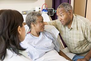 Doctor Explaining, Senior Couple Looking At Each Other