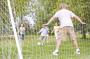 Five young friends playing soccer