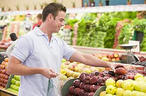 Man shopping for apples at a grocery store