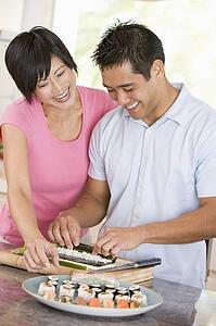 Couple Preparing Sushi Together 