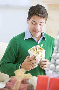 Man Excited To Open Christmas Present