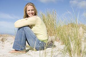Young woman posing on a sand hill