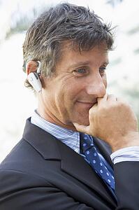 Businessman wearing headset outdoors
