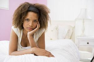 Teenage Girl Lying On Bed