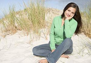 Young woman posing on a sand hill