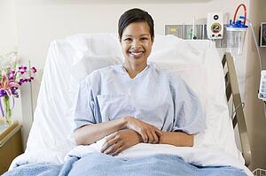 Woman Sitting In Hospital Bed
