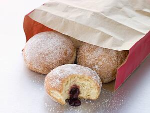 Bag Of Raspberry Jam Doughnuts With A Bite Taken
