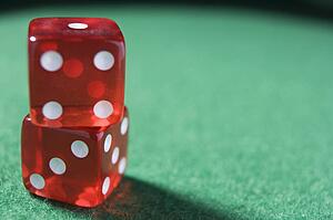 Dice sitting on a poker table (close up/selective focus)