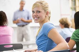 Female student with other students in classroom
