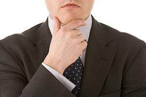 Businessman Holding His Hand Up To His Chin