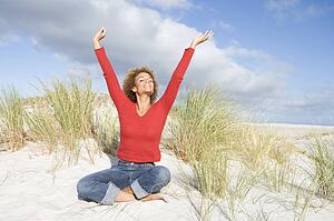 Young woman posing on a sand hill