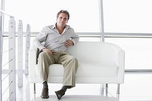 Businessman sitting in office lobby