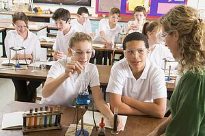 Students performing science experiments in classroom