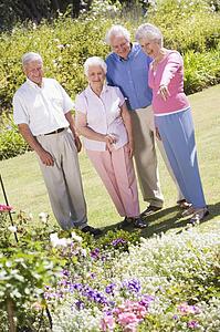 Two senior couples in a flower garden