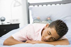 Teenage Boy Lying On Bed