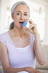 Woman Using An Inhaler