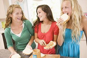 Teenage Girls Making Sandwiches