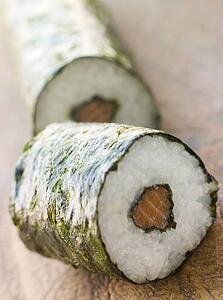 Roll of Salmon Sushi on a Board