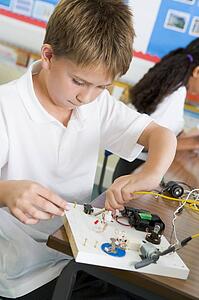 Student in class with electronic project (selective focus)