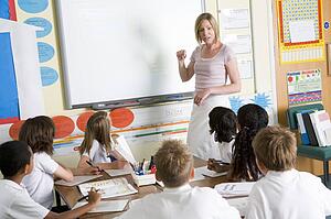 Students in class with teacher at board
