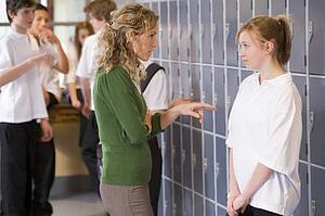Female teacher reprimanding a female student