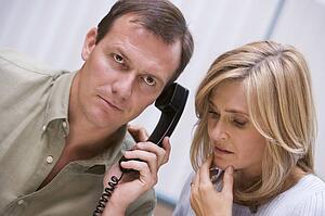 Couple receiving a bad news phone call from clinic