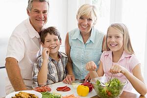 Grandparents And Grandchildren Prepare A meal, mealtime Together 