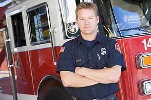 Fireman standing in front of fire engine
