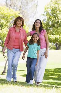Grandmother with adult daughter and grandchild in park