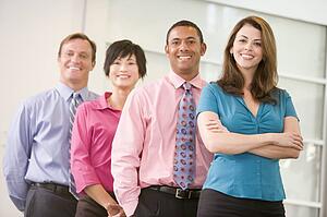 Business team standing indoors smiling