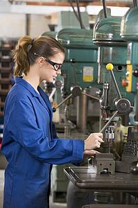 Machinist working on machine