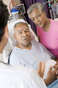 Senior Couple Talking To Doctor