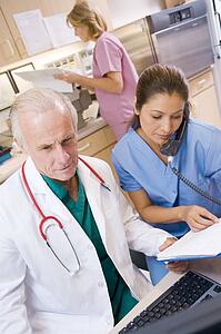 A Doctor And Nurse At The Reception Area Of A Hospital