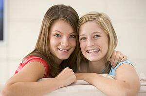 Two women in living room smiling