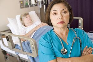 Doctor Standing With Arms Crossed In Patients Room
