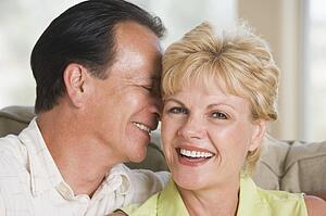Couple relaxing in living room and smiling