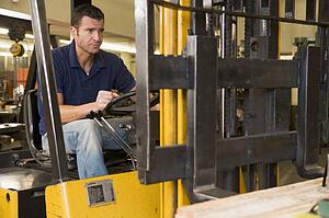 Warehouse worker in forklift