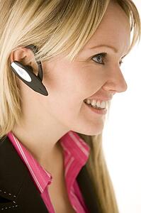 Businesswoman Talking On Hands Free Phone 
