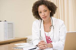 Doctor with laptop in doctor's office