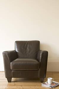 Chair with coffee mug and magazine beside it
