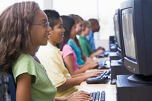 Six children at computer terminals (depth of field/high key)