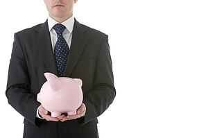 Businessman Holding Piggy Bank 