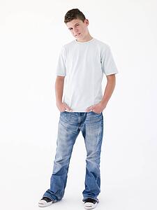 Teenage boy standing with hands in pockets