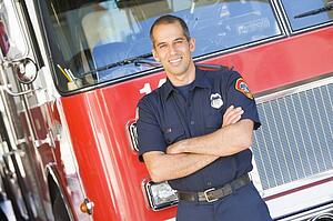 Fireman standing in front of fire engine