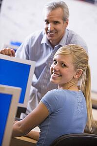 Teacher with female student in computer class