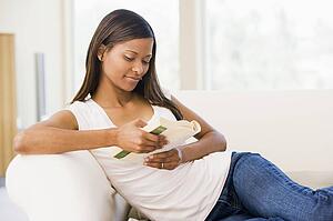 Woman in living room reading book