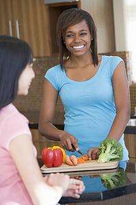 Women Laughing With Friend While Preparing meal, mealtime