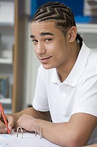 Student writing and studying