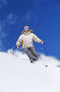 Skier coming down hill smiling