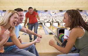 Man bowling with friends